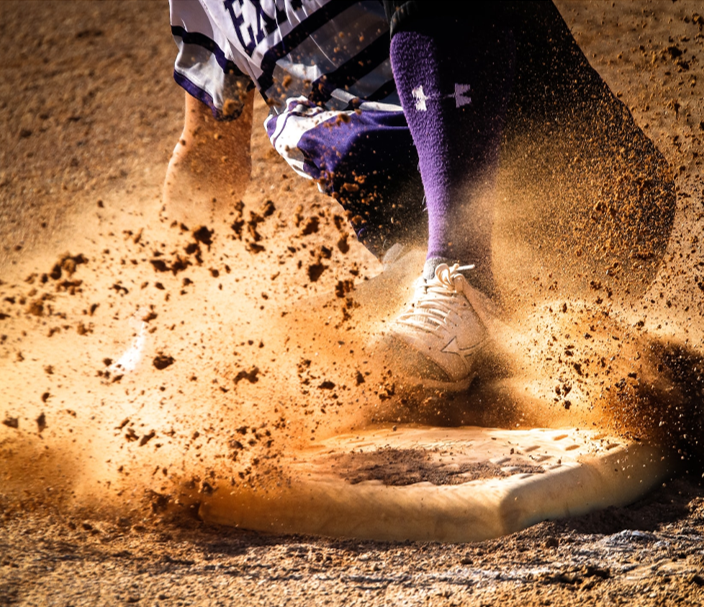 Photo of baseball player sliding into base